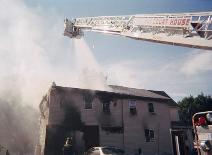 CMCH Ladder Truck uses the bucket to suppress the fire on this home in 2003